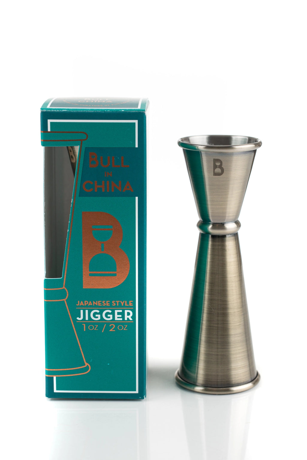 Brass jigger with 'Bull in China' branding next to its packaging on a white background