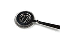Metallic cocktail strainer on a white background