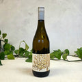 Wine bottle with decorative label on a light background