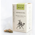 A box of Genmaicha organic green tea from Silk Road Teas, shown with a single tea bag containing loose tea leaves on a clean white background.